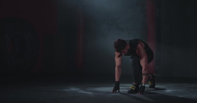 In the dark cross fitness class bodybuilding guy take the running poses then start to run doing his hard workout we ll get sweating