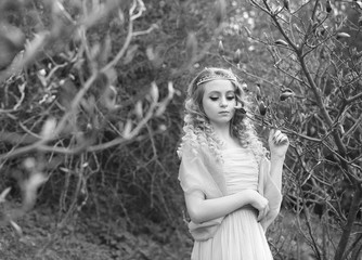  stunning black and white portrait young beautiful girl in a light dress in the garden where magnolias bloom