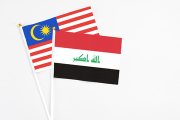 Iraq and Malaysia stick flags on white background. High quality fabric, miniature national flag. Peaceful global concept.White floor for copy space.