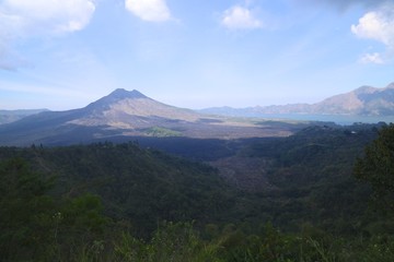 Volcanoes and forests of tropical evergreen island, sky and clouds