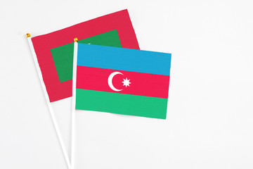 Azerbaijan and Maldives stick flags on white background. High quality fabric, miniature national flag. Peaceful global concept.White floor for copy space.