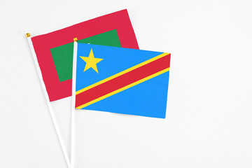 Congo and Maldives stick flags on white background. High quality fabric, miniature national flag. Peaceful global concept.White floor for copy space.