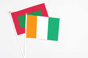 Cote D'Ivoire and Maldives stick flags on white background. High quality fabric, miniature national...