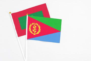 Eritrea and Maldives stick flags on white background. High quality fabric, miniature national flag. Peaceful global concept.White floor for copy space.