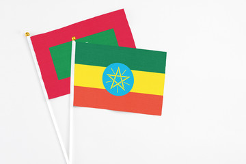 Ethiopia and Maldives stick flags on white background. High quality fabric, miniature national flag. Peaceful global concept.White floor for copy space.