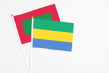 Gabon and Maldives stick flags on white background. High quality fabric, miniature national flag....