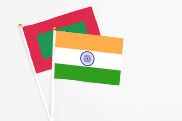 India and Maldives stick flags on white background. High quality fabric, miniature national flag. Peaceful global concept.White floor for copy space.