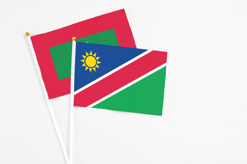 Namibia and Maldives stick flags on white background. High quality fabric, miniature national flag. Peaceful global concept.White floor for copy space.