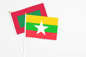 Myanmar and Maldives stick flags on white background. High quality fabric, miniature national flag. Peaceful global concept.White floor for copy space.