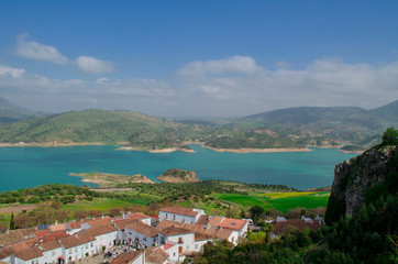 View of the lake of Zahara de la Sierra and its white village. Whitewashed walls and red or brown tiled roofs. Cadiz, Andalusia, Spain