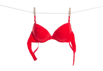Red bra on clothespins rope on white background isolation