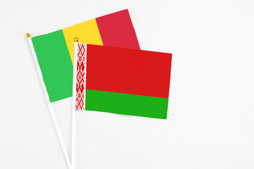 Belarus and Mali stick flags on white background. High quality fabric, miniature national flag. Peaceful global concept.White floor for copy space.