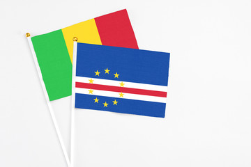 Cape Verde and Mali stick flags on white background. High quality fabric, miniature national flag. Peaceful global concept.White floor for copy space.