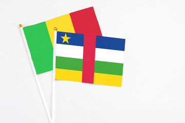 Central African Republic and Mali stick flags on white background. High quality fabric, miniature national flag. Peaceful global concept.White floor for copy space.