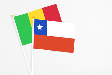 Chile and Mali stick flags on white background. High quality fabric, miniature national flag. Peaceful global concept.White floor for copy space.
