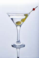 Cocktail martini dry with three olives in isolated glass on white background