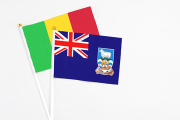 Falkland Islands and Mali stick flags on white background. High quality fabric, miniature national flag. Peaceful global concept.White floor for copy space.