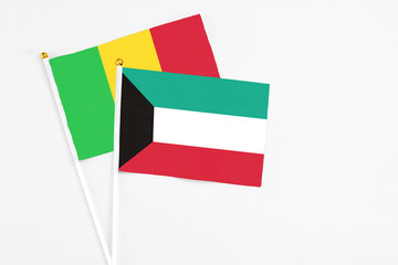 Kuwait and Mali stick flags on white background. High quality fabric, miniature national flag. Peaceful global concept.White floor for copy space.