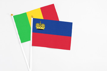 Liechtenstein and Mali stick flags on white background. High quality fabric, miniature national flag. Peaceful global concept.White floor for copy space.