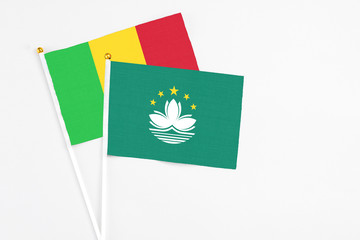Macao and Mali stick flags on white background. High quality fabric, miniature national flag. Peaceful global concept.White floor for copy space.