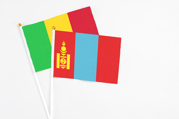 Mongolia and Mali stick flags on white background. High quality fabric, miniature national flag. Peaceful global concept.White floor for copy space.