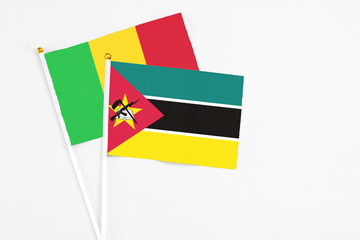 Mozambique and Mali stick flags on white background. High quality fabric, miniature national flag. Peaceful global concept.White floor for copy space.