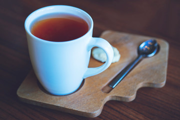Hot tea cup on a wooden table background