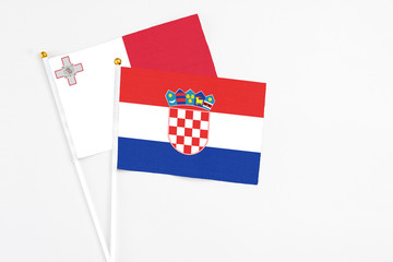 Croatia and Malta stick flags on white background. High quality fabric, miniature national flag....