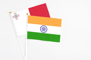 India and Malta stick flags on white background. High quality fabric, miniature national flag. Peaceful global concept.White floor for copy space.