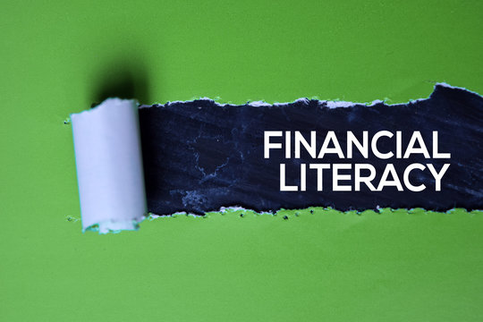 Financial Literacy Text written in torn paper