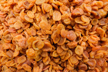 Dried apricot fruit forming a background.