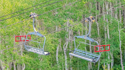 Panorama frame Chairlifts over mountain and trees on a sunny summer day in Park City ski resort