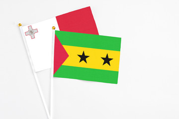 Sao Tome And Principe and Malta stick flags on white background. High quality fabric, miniature national flag. Peaceful global concept.White floor for copy space.