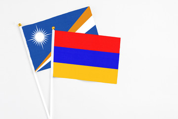 Armenia and Marshall Islands stick flags on white background. High quality fabric, miniature national flag. Peaceful global concept.White floor for copy space.