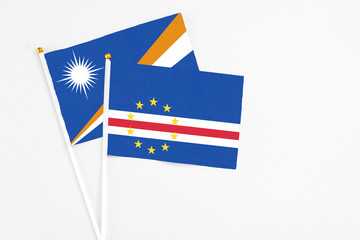 Cape Verde and Marshall Islands stick flags on white background. High quality fabric, miniature national flag. Peaceful global concept.White floor for copy space.