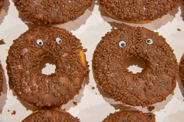 Close up on two donuts with googly eyes