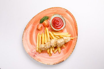 Small kid's meal. A plate of chicken barbecue with french fries, cherry tomato, ketchup on a white background. Top view children's menu food