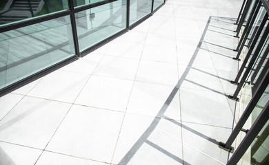 office glass exterior side walk outdoor space with tile paved floor background textured surface with shadow from fence , architecture photography 