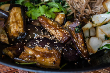 Asian egg plant, mushrooms, cabbage stir fried in wok.