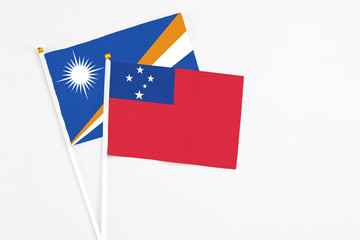 Samoa and Marshall Islands stick flags on white background. High quality fabric, miniature national flag. Peaceful global concept.White floor for copy space.