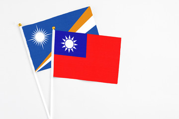Taiwan and Marshall Islands stick flags on white background. High quality fabric, miniature national flag. Peaceful global concept.White floor for copy space.