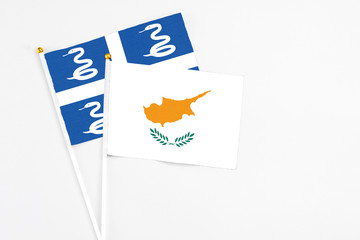 Cyprus and Martinique stick flags on white background. High quality fabric, miniature national flag. Peaceful global concept.White floor for copy space.