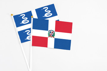 Dominican Republic and Martinique stick flags on white background. High quality fabric, miniature national flag. Peaceful global concept.White floor for copy space.