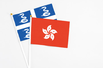 Hong Kong and Martinique stick flags on white background. High quality fabric, miniature national flag. Peaceful global concept.White floor for copy space.