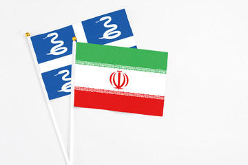 Iran and Martinique stick flags on white background. High quality fabric, miniature national flag. Peaceful global concept.White floor for copy space.