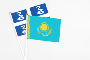 Kazakhstan and Martinique stick flags on white background. High quality fabric, miniature national flag. Peaceful global concept.White floor for copy space.