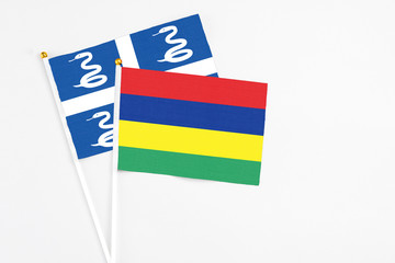 Mauritius and Martinique stick flags on white background. High quality fabric, miniature national flag. Peaceful global concept.White floor for copy space.