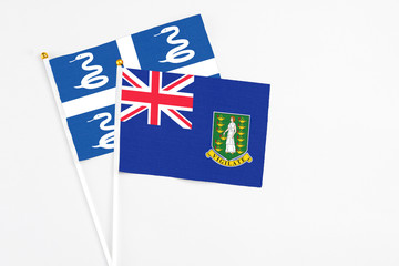 Fototapeta premium British Virgin Islands and Martinique stick flags on white background. High quality fabric, miniature national flag. Peaceful global concept.White floor for copy space.