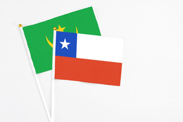Chile and Mauritania stick flags on white background. High quality fabric, miniature national flag. Peaceful global concept.White floor for copy space.