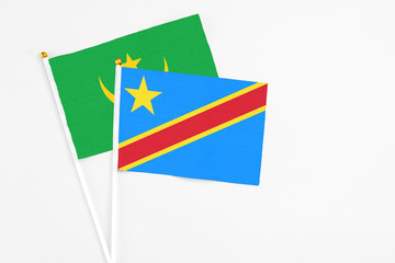 Congo and Mauritania stick flags on white background. High quality fabric, miniature national flag. Peaceful global concept.White floor for copy space.